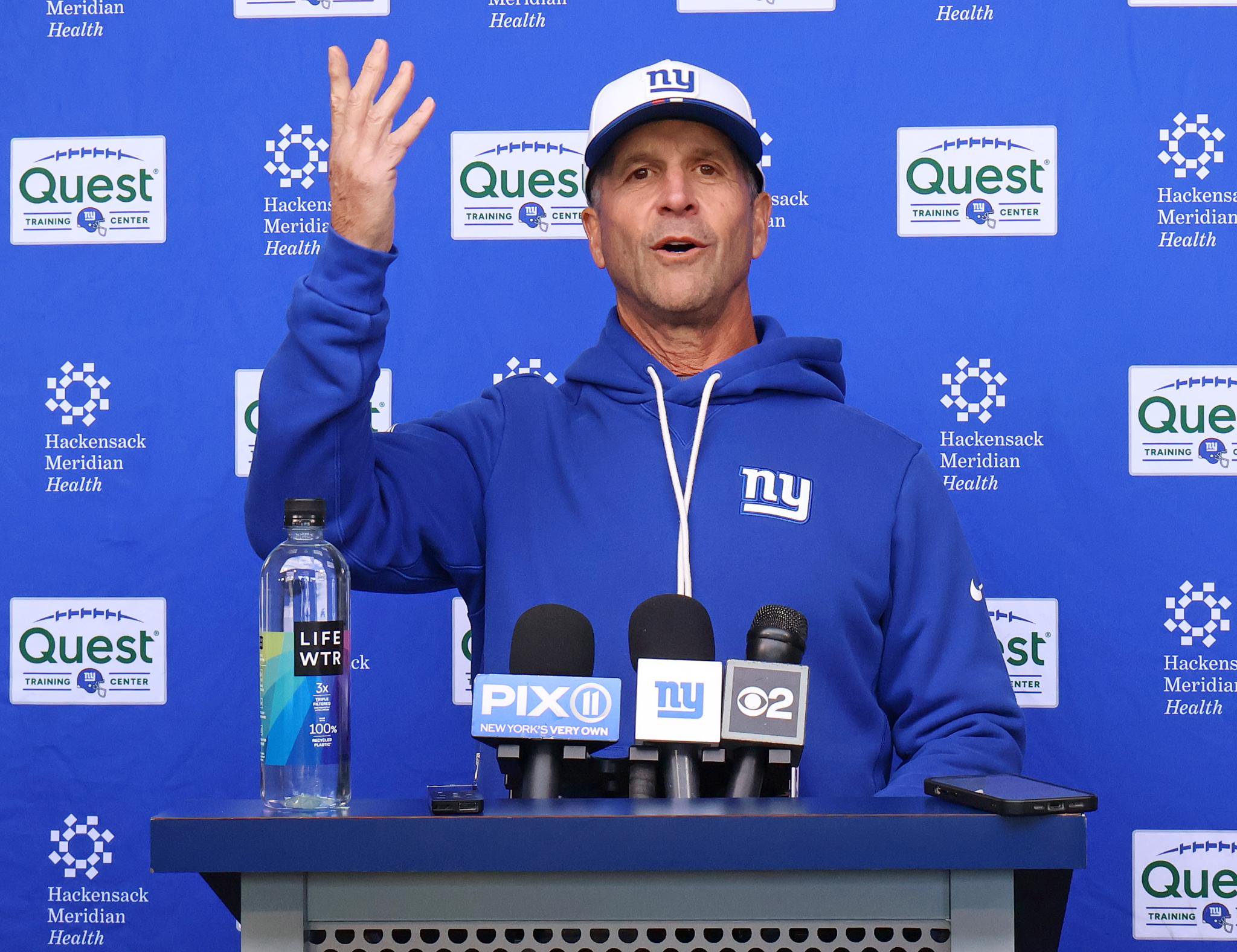 New York Giants head coach John Harbaugh speaks at a press conference.