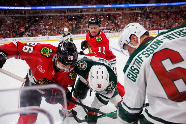 Blackhawks left wing Andrew Mangiapane (26) Wild center Mason Shaw (18) and Wild defenseman Viking Gustafsson Nyberg (6) fight for possession of the puck during the second period of the Blackhawks preseason match at the United Center Sept. 21, 2026 in Chicago. (Armando L. Sanchez/Chicago Tribune)