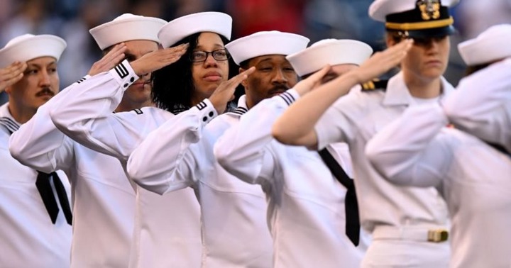 Members of the U.S. Navy stand for the national anthem before a baseball game on May 10 in Washington, D.C.