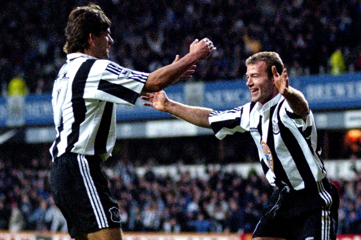 Alan Shearer of Newcastle United celebrates scoring against with Philippe Albert