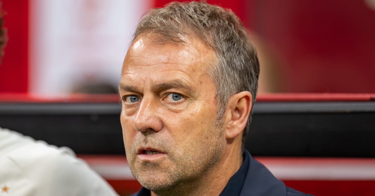 Football manager Hansi Flick looking to his right as a head coach in a technical area