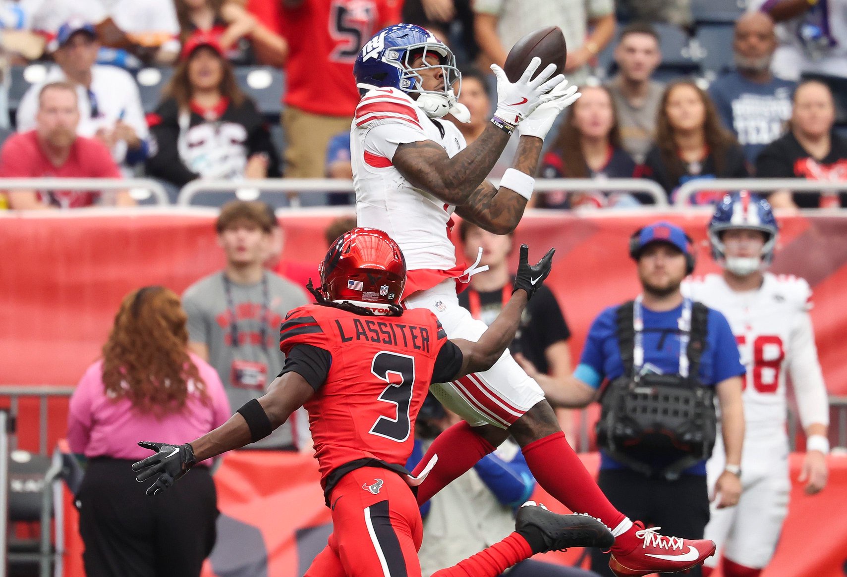 Oct 25, 2026; Houston, Texas, USA;  New York Giants wide receiver Malik Nabers (1) makes a reception as Houston Texans cornerback Kamari Lassiter (3) defends during the first quarter at Reliant Stadium.  Mandatory Credit: Troy Taormina-Imagn Images