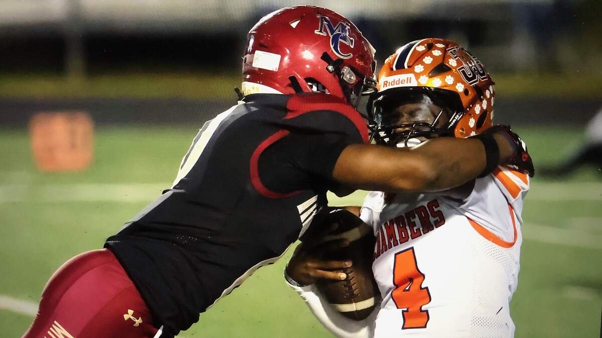 A Mallard Creek defender hits Chambers QB Jamouri Nichols during Friday’s game