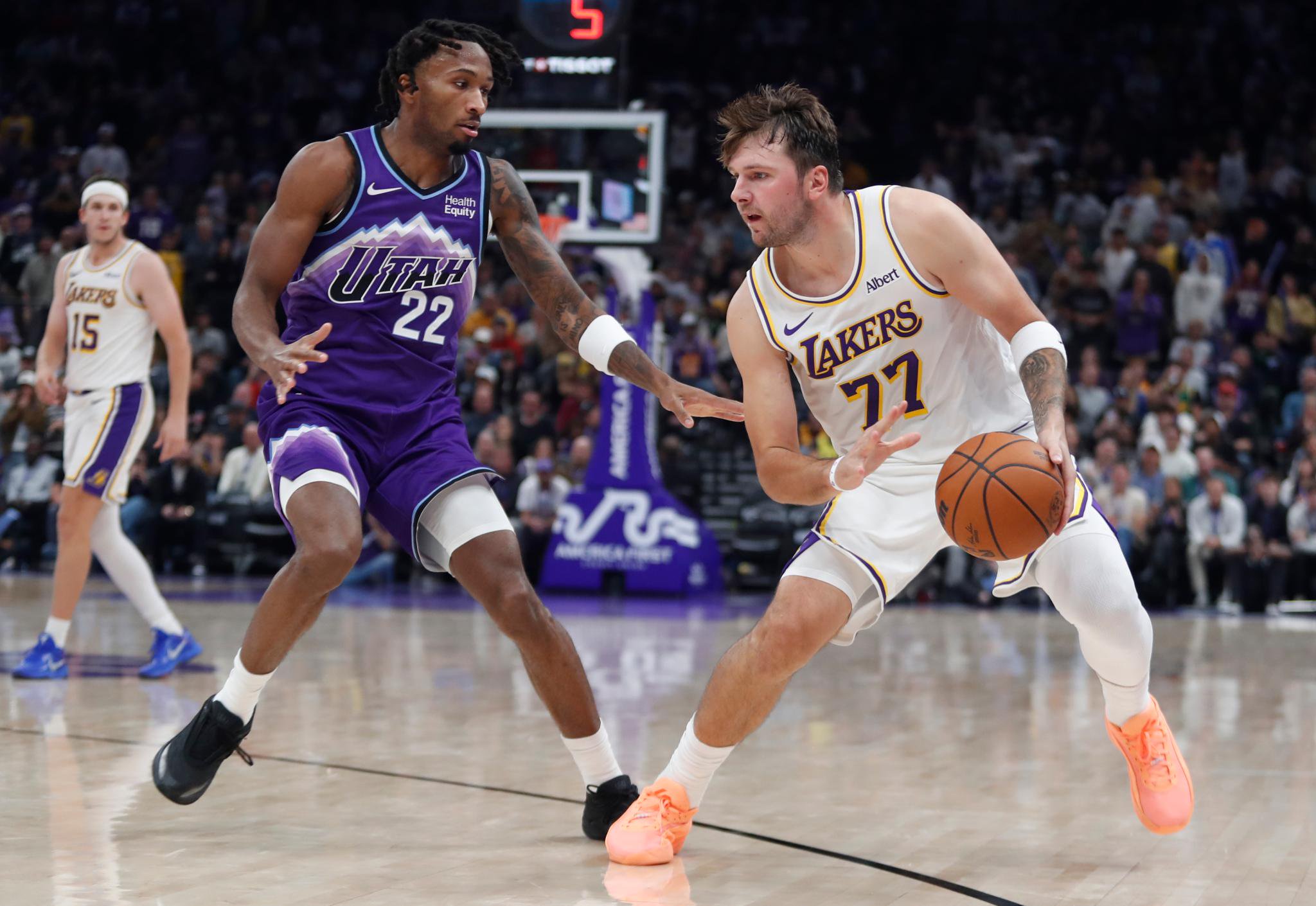 Luka Doncic of the Los Angeles Lakers handles the ball while guarded by Darryn Peterson of the Utah Jazz during an NBA game.