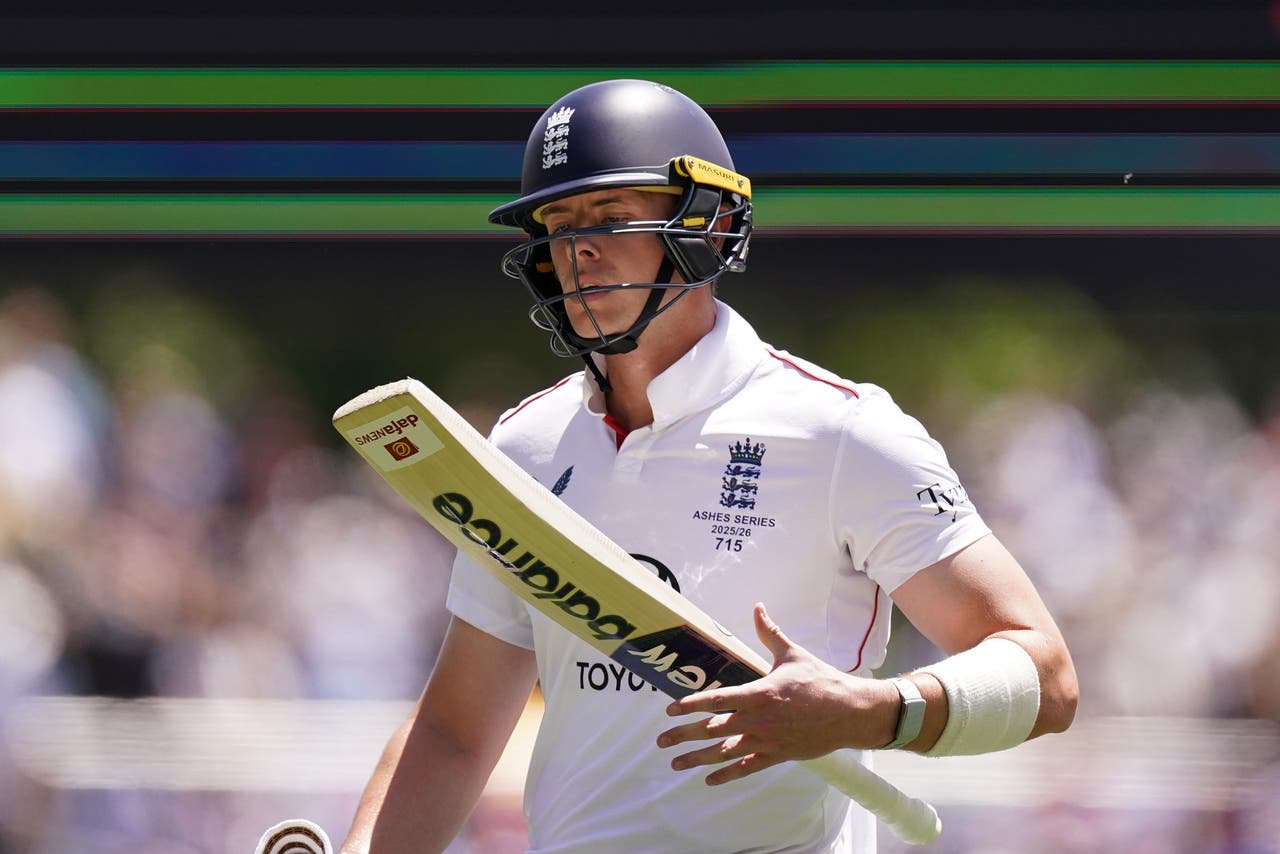 Jamie Smith looks at his bat after being dismissed