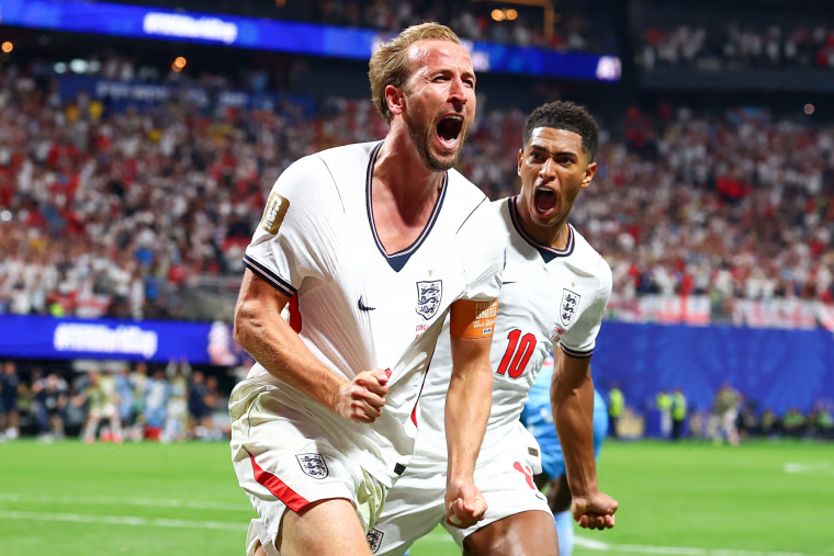 Harry Kane, left, and Jude Bellingham run and yell in celebration on the soccer field