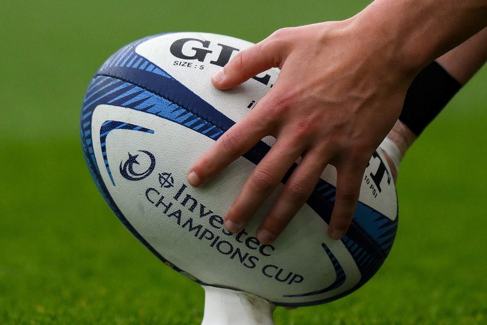 A general view of a player placing a rugby ball on a kicking tee during a Champions Cup game