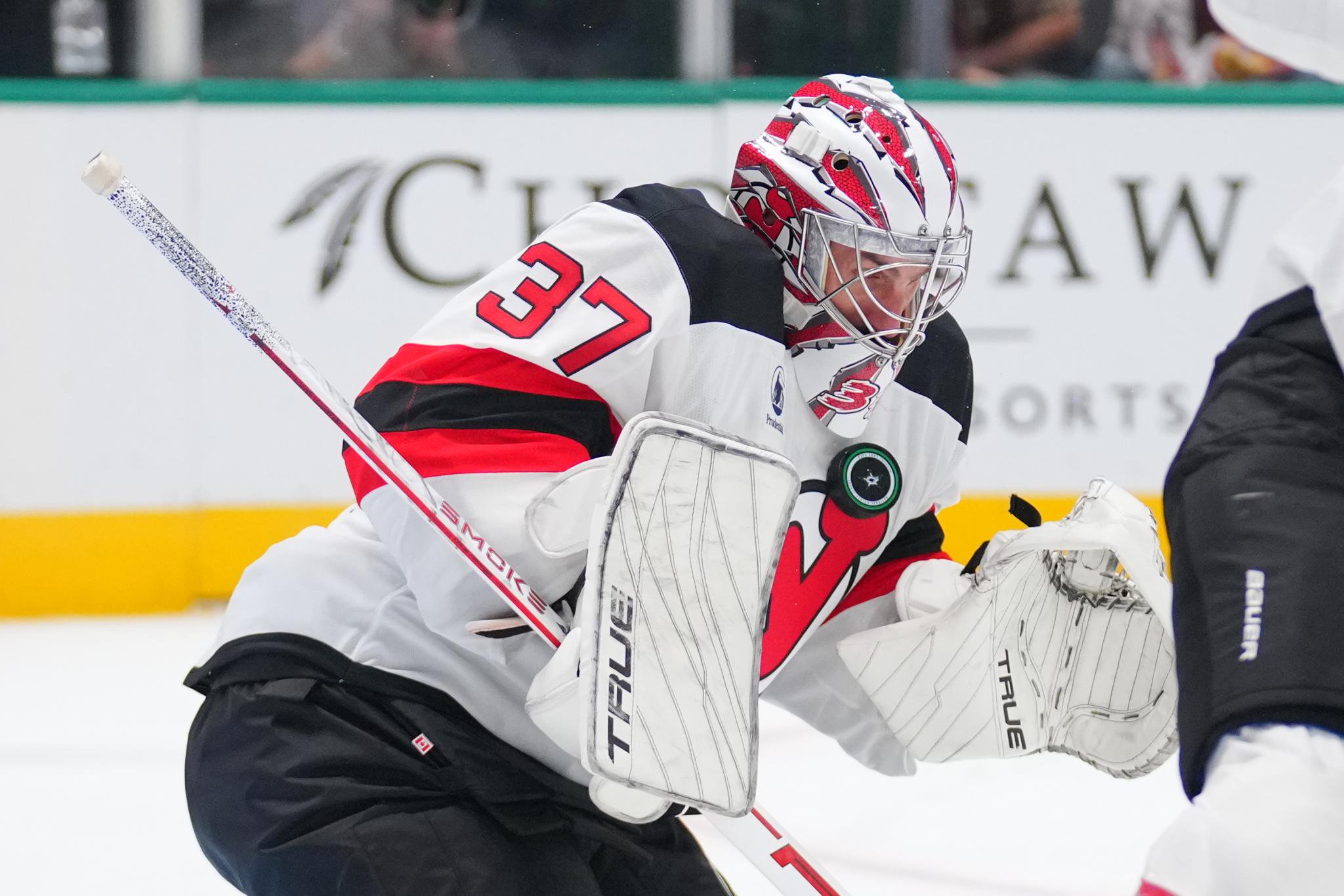 New Jersey Devils goaltender Connor Hellebuyck blocks a shot.