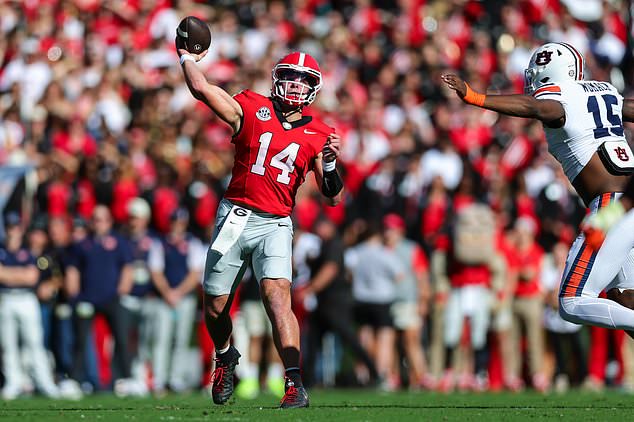 Georgia quarterback Gunner Stockton (14) throws a touchdown pass during the first half of an NCAA college football game against Auburn, Saturday, Oct. 17, 2026, in Athens, Ga. (AP Photo/Colin Hubbard)