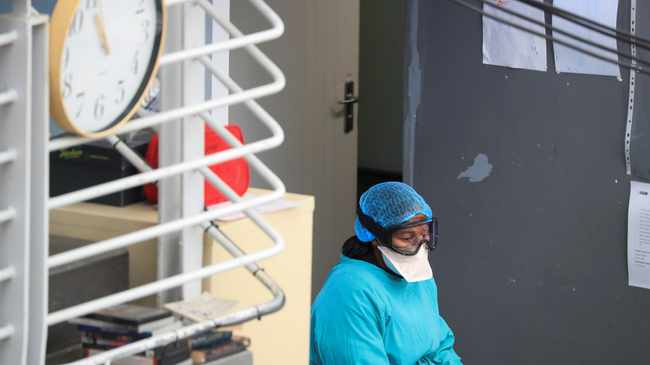 A health worker takes a break from her work at a temporary field hospital set up by Medecins Sans Frontieres (MSF) during the coronavirus disease (Covid-19) outbreak in Khayelitsha, <a class=