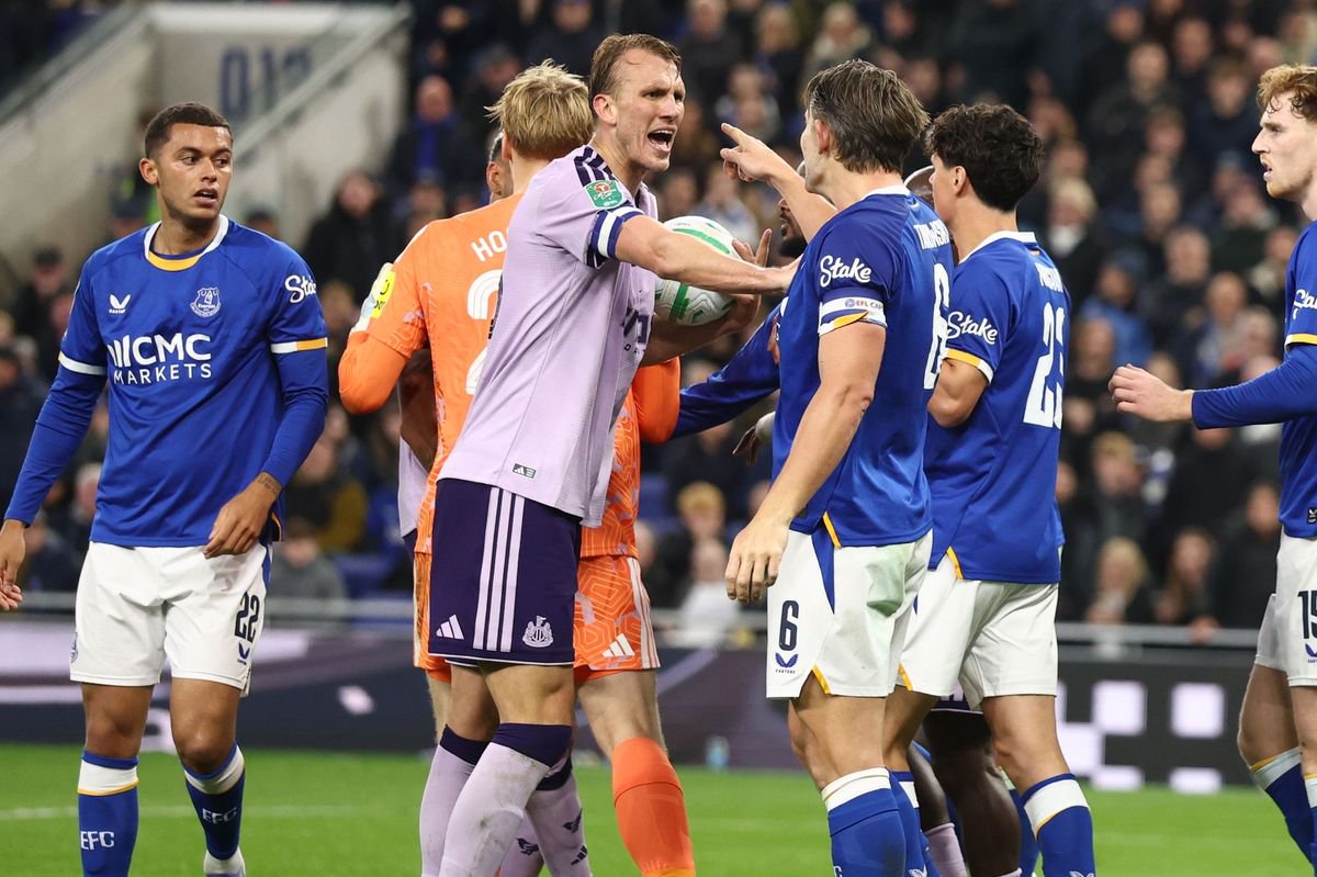 Newcastle United's Dan Burn clashes with Everton's James Tarkowski