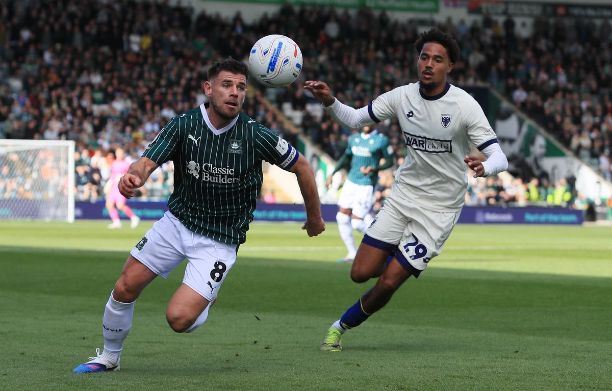 Joe Edwards of Plymouth Argyle battles for the ball with Aron Sasu of AFC Wimbledon during the Sky Bet League 1 match between Plymouth Argyle and AFC Wimbledon on 10 October 2026, Home Park, Plymouth, Devon - Photo: Dave Rowntree/PPAUK