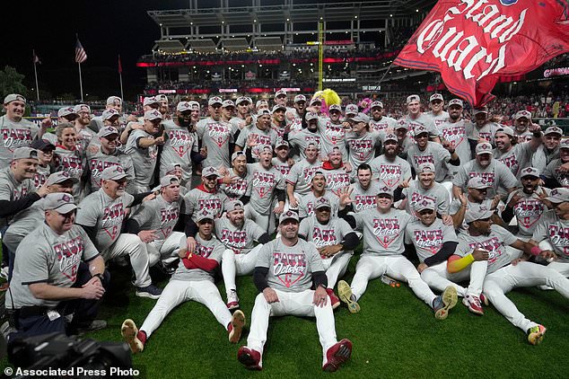 Cleveland Guardians players and coaches celebrate after Game 5 of baseball's American League Division Series against the Chicago White Sox, Saturday, Oct. 10, 2026, in Cleveland. (AP Photo/Sue Ogrocki)