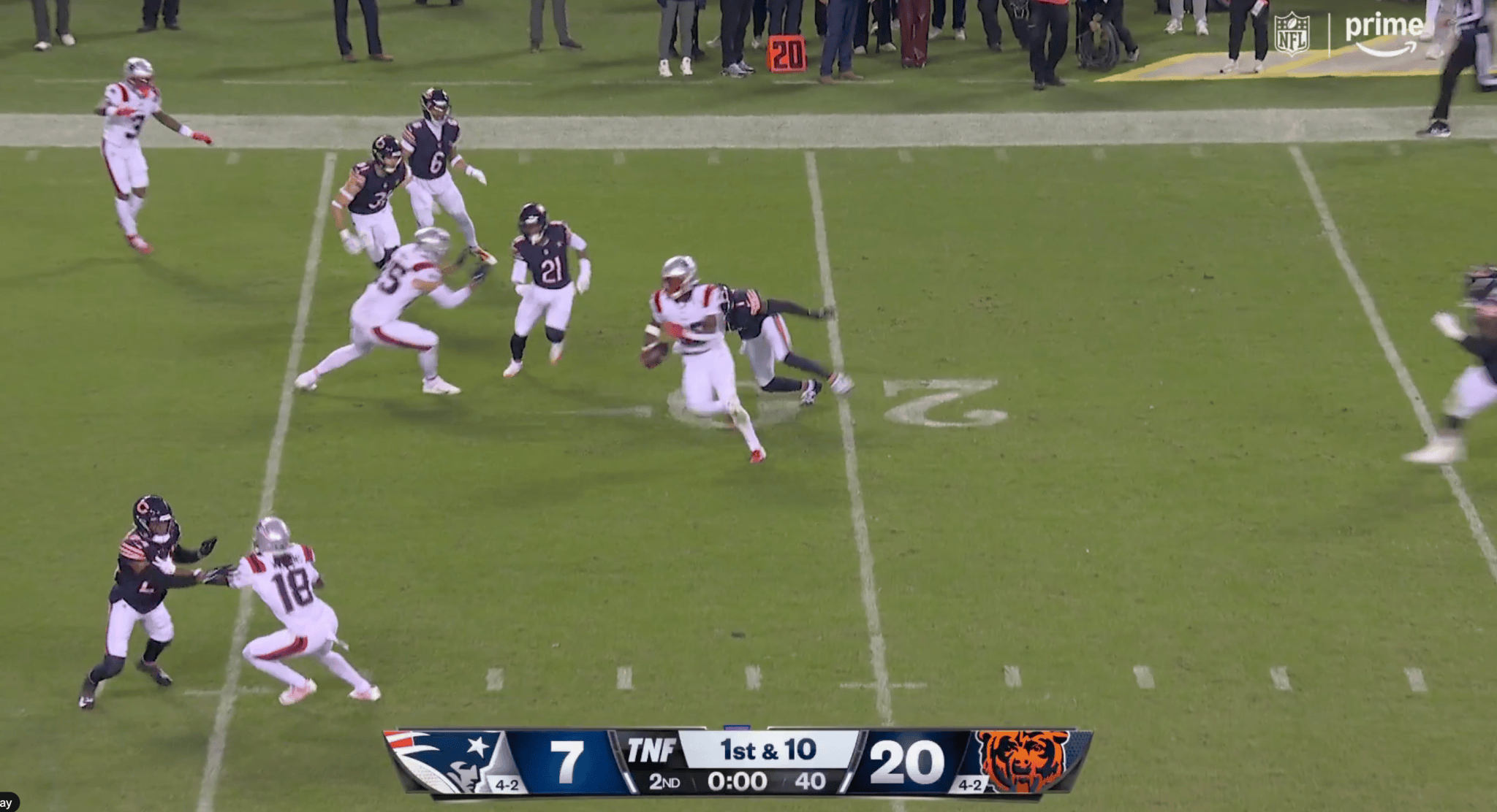 An overhead view of an NFL football game between the Patriots and the Bears, with the score 20-7 in the second quarter.
