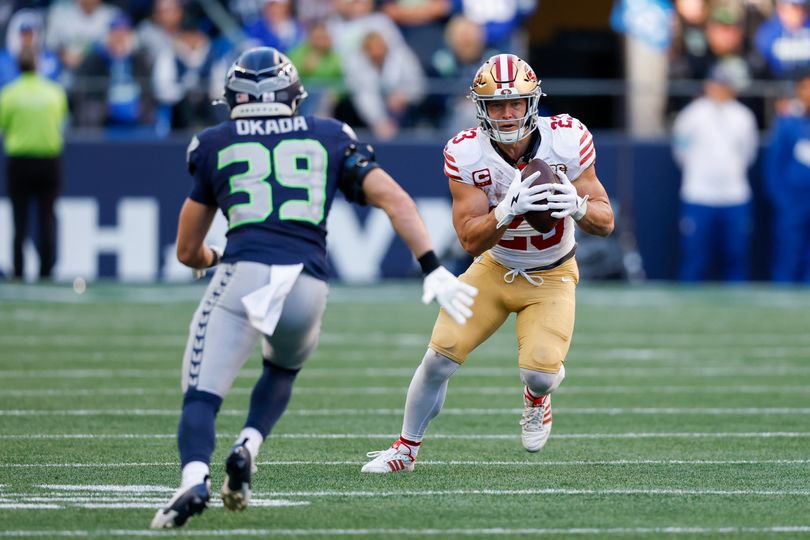 Christian McCaffrey rushes the ball against Seattle