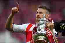 Aaron Ramsey of Arsenal celebrates with the trophy after The Emirates FA Cup Final between Arsenal and Chelsea at Wembley Stadium on May 27, 2017 i...