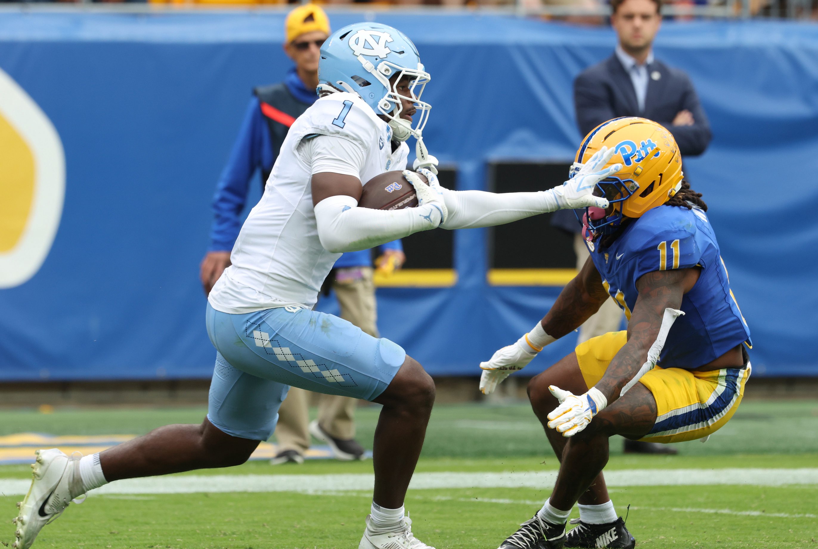 Oct 10, 2026; Pittsburgh, Pennsylvania, USA;  North Carolina Tar Heels defensive back Gregory Smith III (1) returns an interception against Pittsburgh Panthers running back La'vell Wright (11) during the third quarter at Acrisure Stadium.  Mandatory Credit: Charles LeClaire-Imagn Images