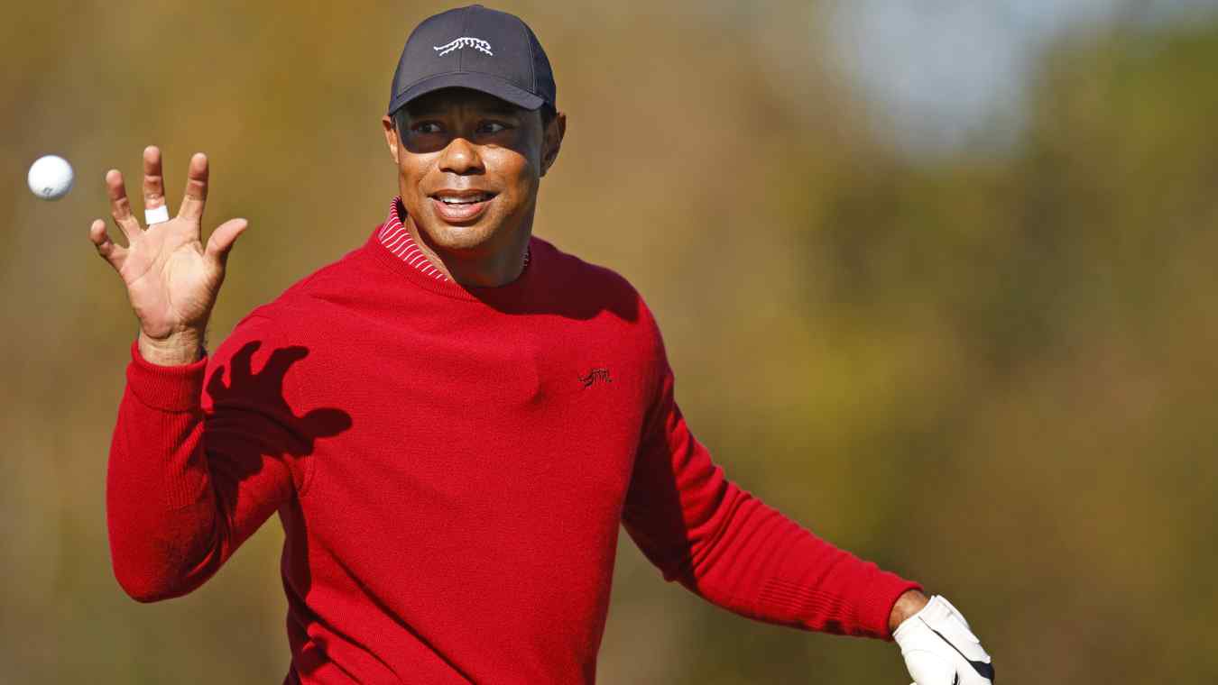 Tiger Woods tosses a golf ball while warming up at the 2024 PNC Championship