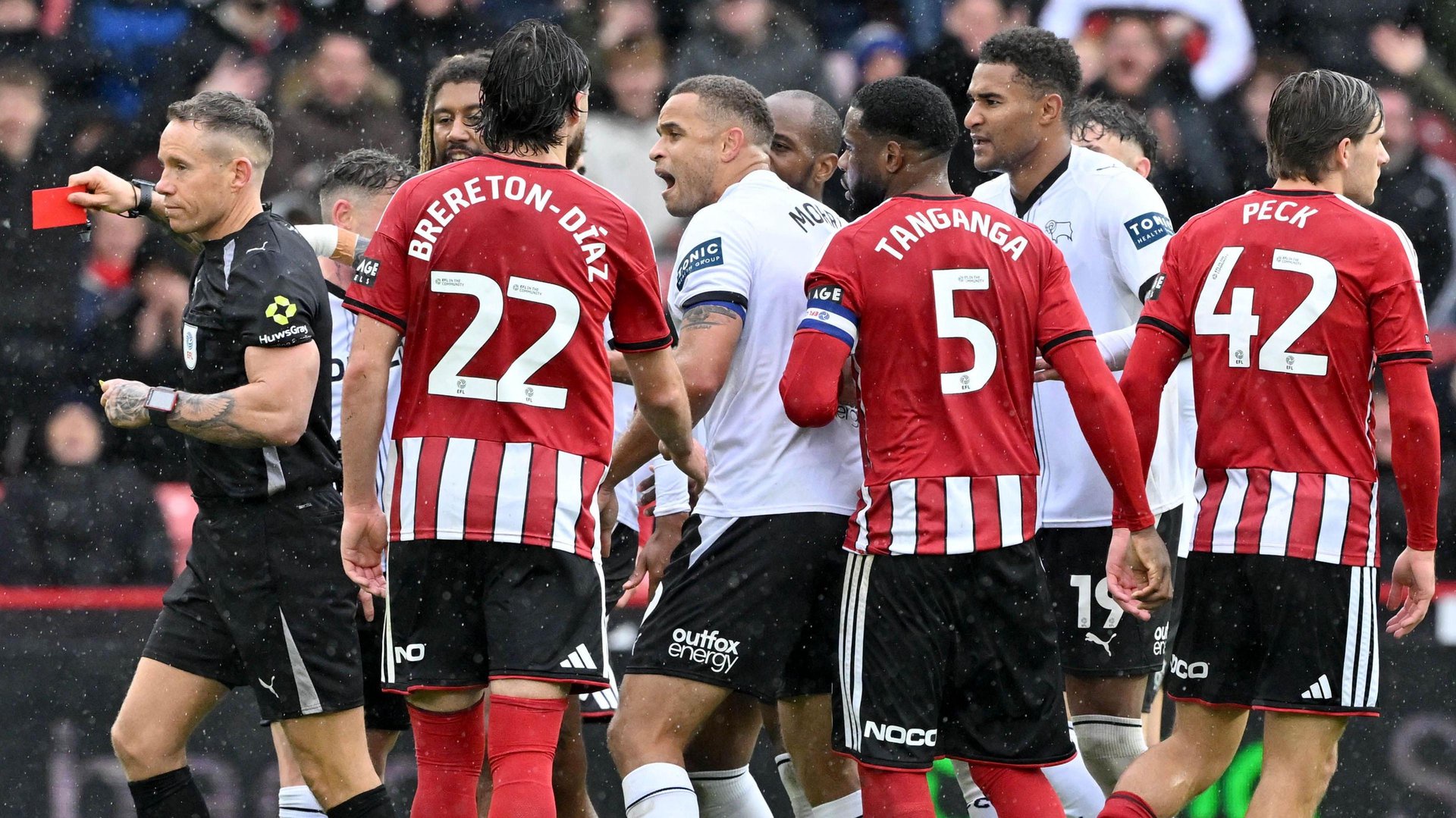 Sheffield United and Derby County players come together as the referee shows a red card to Ram's Dion Sanderson (third left).
