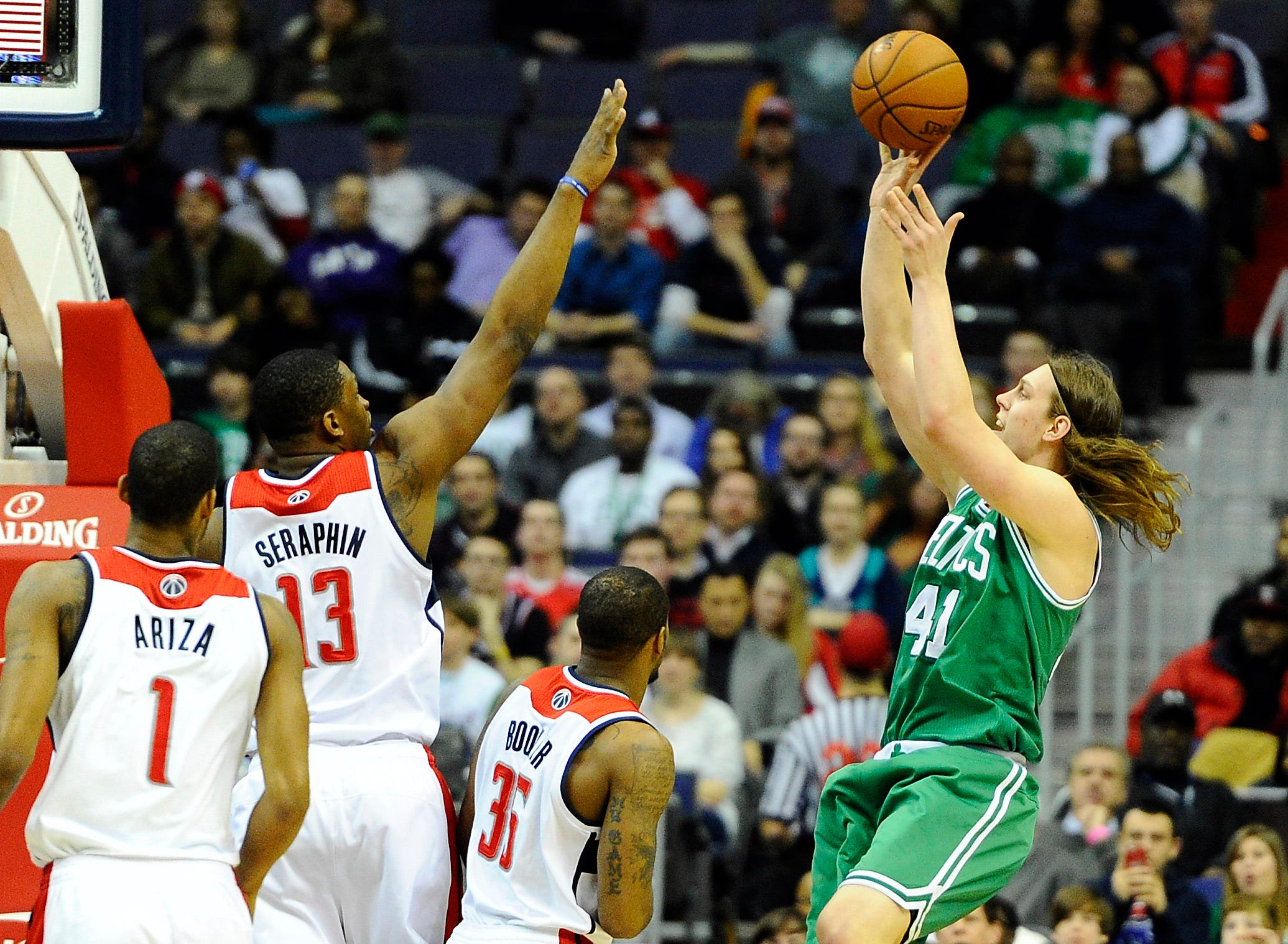 Jan 22, 2014; Washington, DC, USA; Boston Celtics center Kelly Olynyk (41) shoots over Washington Wizards center Kevin Seraphin (13) and power forward Trevor Booker (35) during the first half at Verizon Center. Mandatory Credit: Brad Mills-USA TODAY Sports