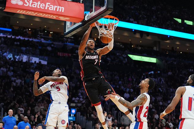 Miami Heat forward Giannis Antetokounmpo (7) dunks over Detroit Pistons forward Ronald Holland II (5) and forward John Collins (20) during the second half of an NBA basketball game, Friday, Oct. 23, 2026, in Miami. (AP Photo/Rebecca Blackwell)
