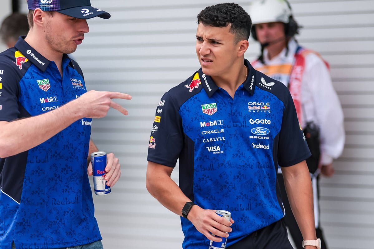An image of Red Bull F1 drivers Isack Hadjar and Max Verstappen in conversation — Photo: © IMAGO