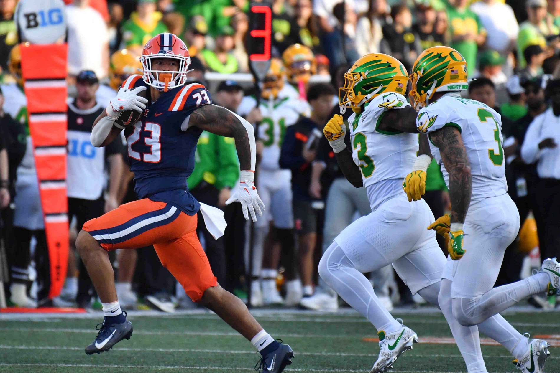 Illinois running back Jordan Anderson out runs Oregon defenders during the second half at Gies Memorial Stadium in Champaign, Illinois on Oct. 24, 2026.