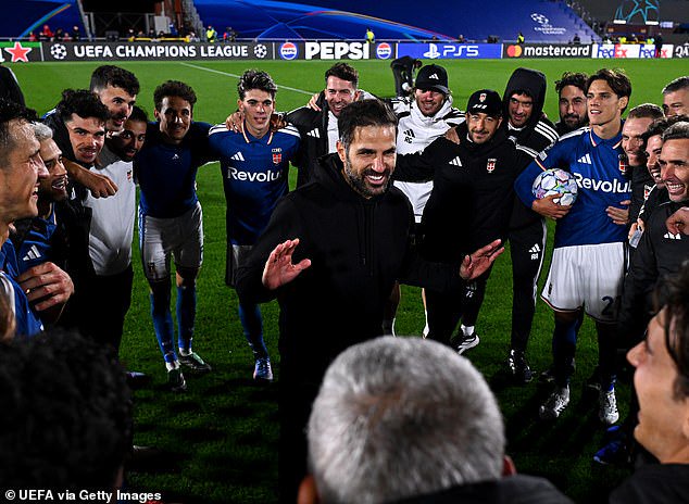 Cesc Fabregas and his Como players celebrate beating Man United - but he wasn't happy