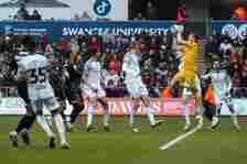 Viktor Johansson of Rotherham United (R) saves the ball from a Swansea cross during the Sky Bet Championship match between Swansea City and Rotherh...