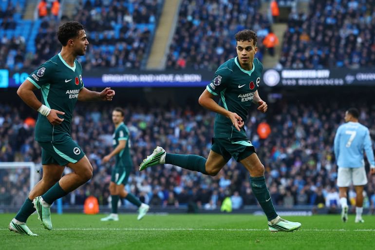 Brighton and Hove Albion's Yasin Ayari celebrates scoring their first goal with Charalampos Kostoulas at Manchester City