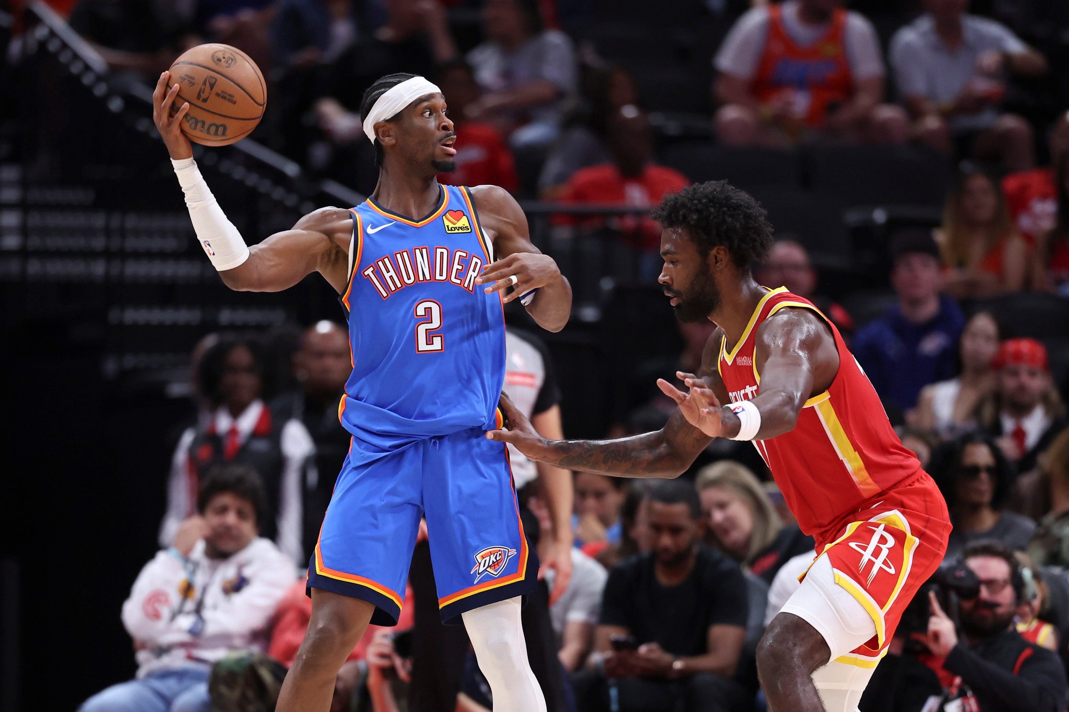 Oct 15, 2026; Houston, Texas, USA; Oklahoma City Thunder guard Shai Gilgeous-Alexander (2) looks to pass the ball as Houston Rockets forward Tari Eason (17) defends during the second quarter at Toyota Center. Mandatory Credit: Troy Taormina-Imagn Images