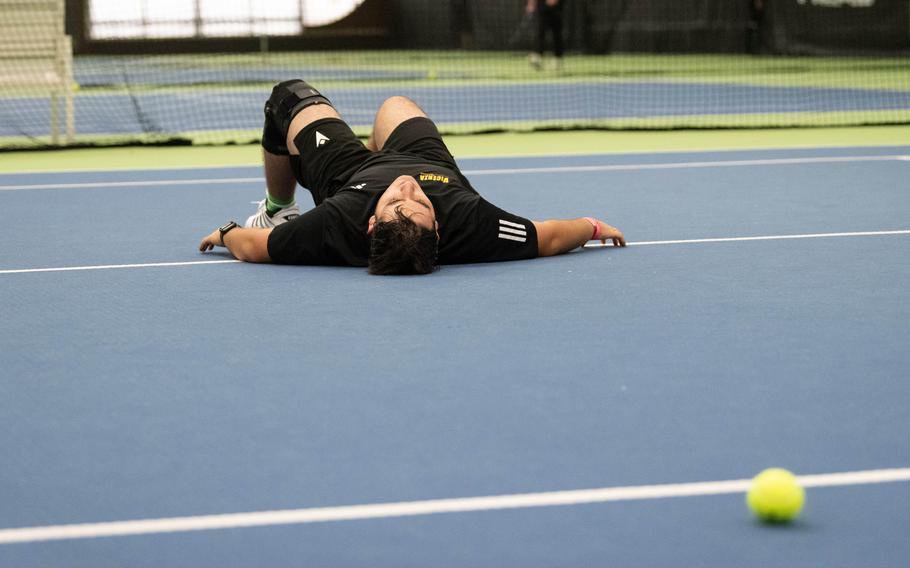 Michael Gillett falls to the court.
