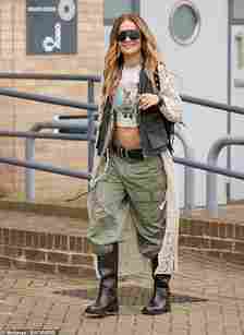 The singer, 33, looked incredible as she showcased a glimpse of her toned stomach in an off-white Tina Turner print crop top while out in London