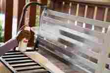 spray painting a bench white