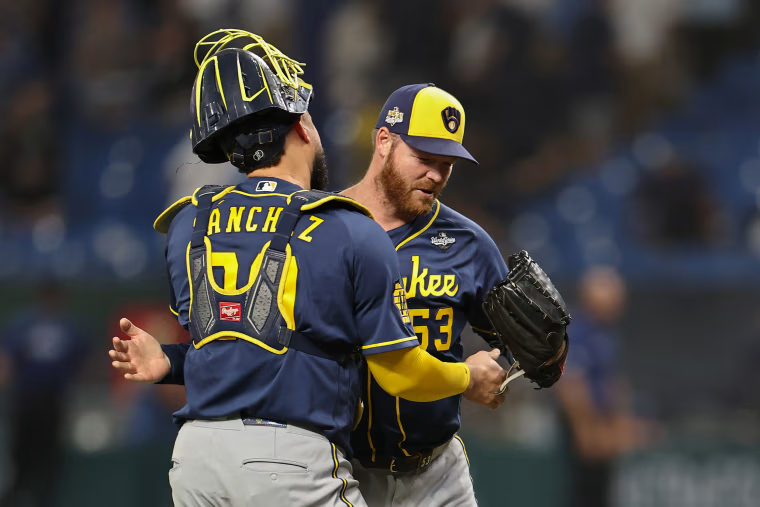 Brandon Woodruff #53 and Gary Sánchez #99 of the Milwaukee Brewers celebrate.