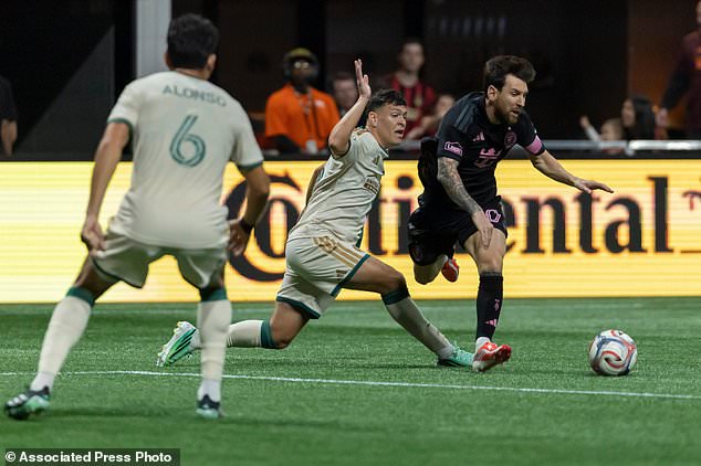 Atlanta United defender Elías Báez, second from right, fouls Inter Miami forward Lionel Messi, right, during the first half of an MLS soccer match Saturday, Oct. 17, 2026, in Atlanta. (AP Photo/Vasha Hunt)