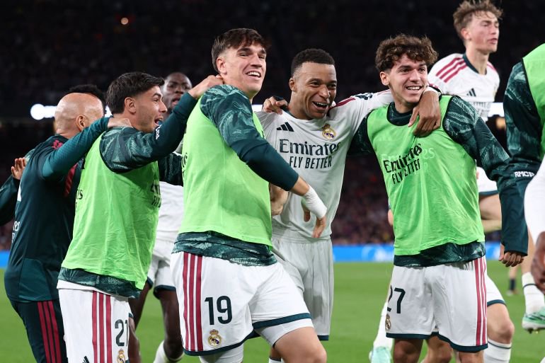 Real Madrid's French forward #10 Kylian Mbappe (2R) celebrates scoring his team's second goal during the Spanish league football match between FC Barcelona and Real Madrid CF at Camp Nou Stadium in Barcelona on October 25, 2026. (Photo by Josep LAGO / AFP)