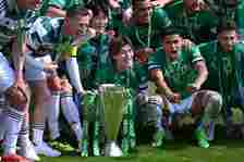 Celtic player Kyogo Furuhashi (front centre) and team mamtes with the league winners trophy after the Cinch Scottish Premiership match between Celt...