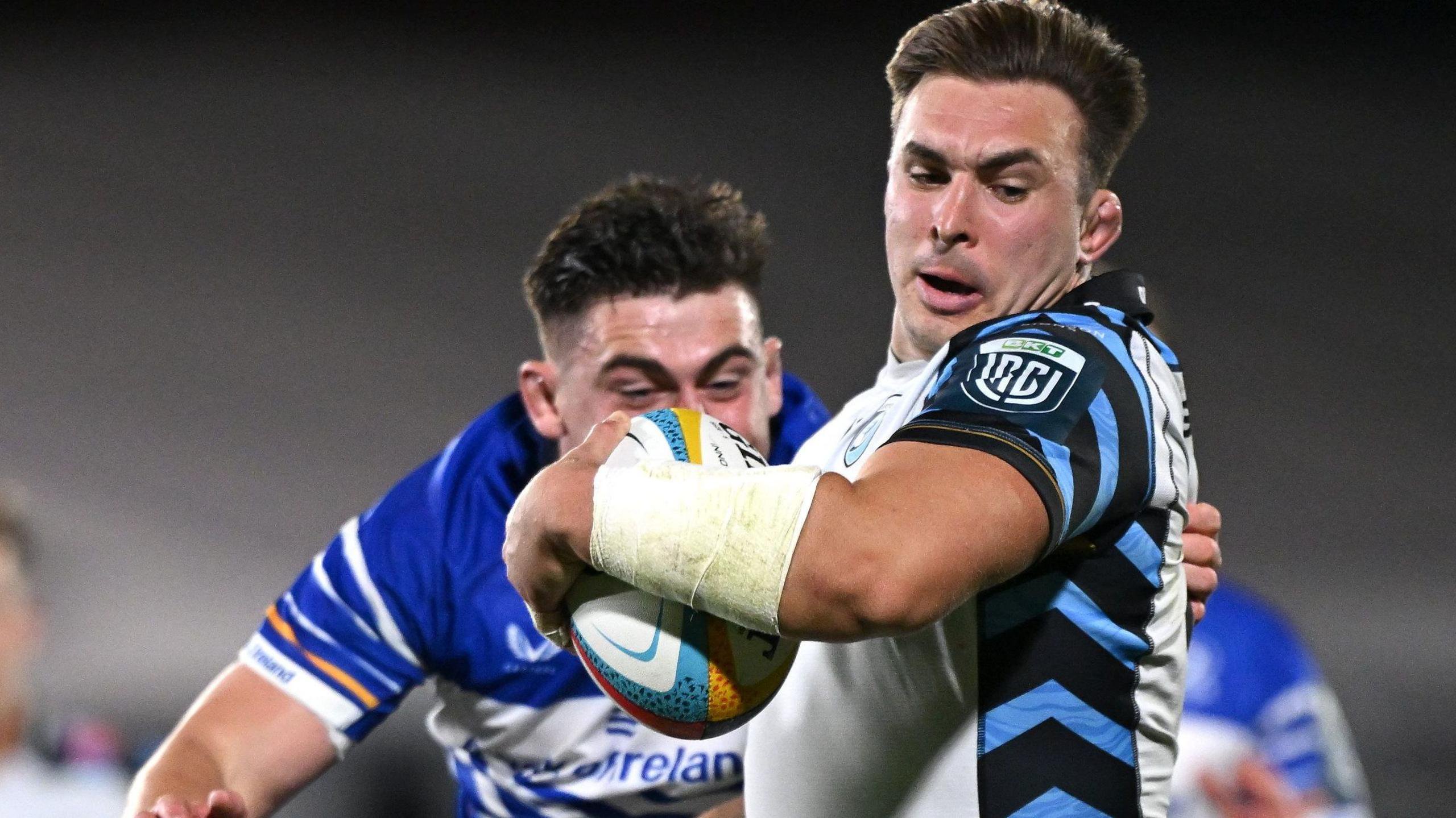 Taine Basham with a rugby ball in his left hand