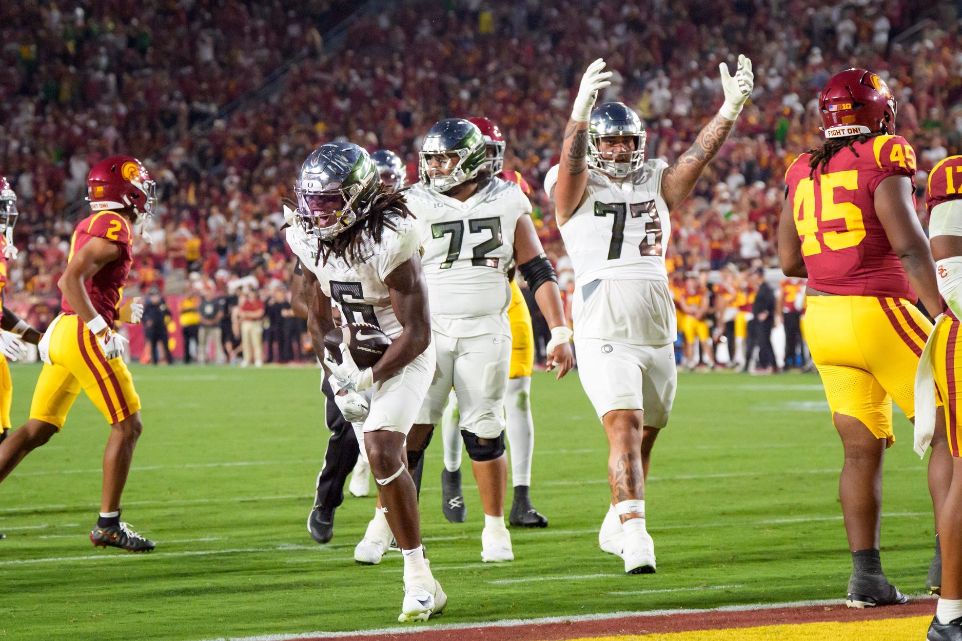 Oregon running back Dierre Hill Jr., left, celebrates a long run as the Oregon Ducks face the USC Trojans on Sept. 26, 2026, at Los Angeles Memorial Coliseum in Los Angeles, California.