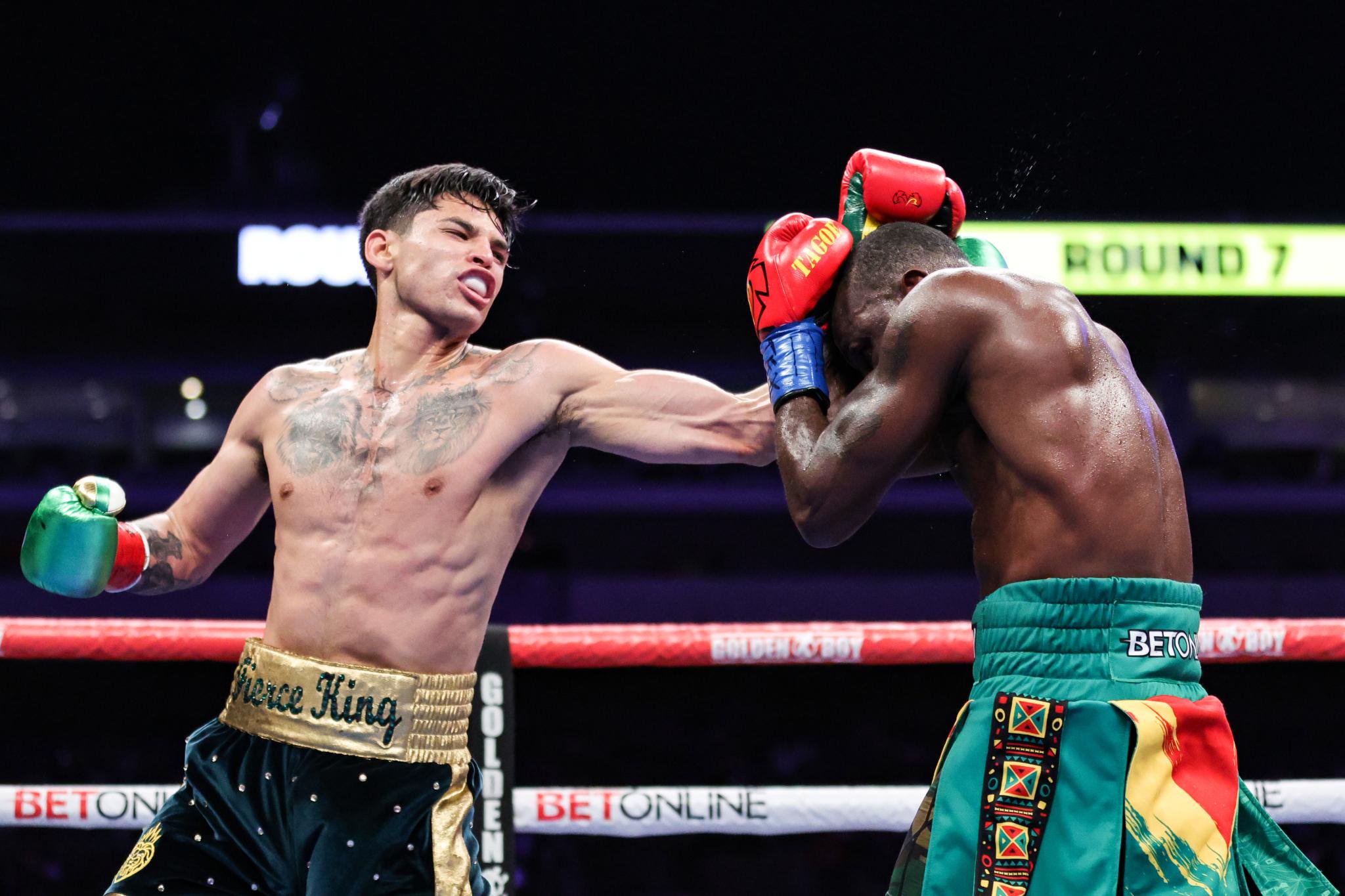 Ryan Garcia punches Emmanuel Tagoe during their boxing match.