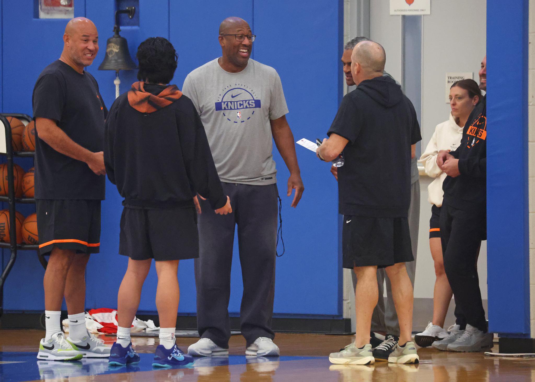 New York Knicks head coach Mike Brown talks with staff during a team practice.