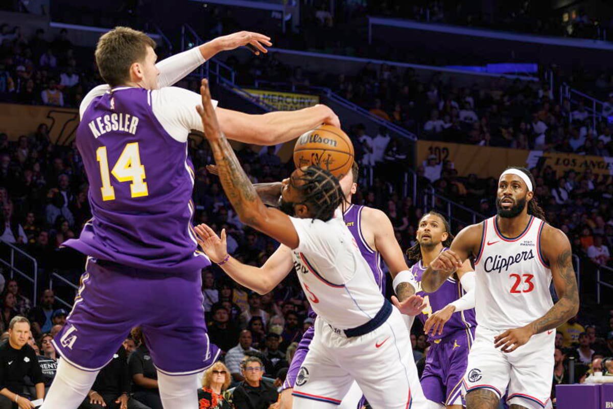 Lakers center Walker Kessler, left, blocks a shot Clippers forward Derrick Jones Jr. during the first half Friday night.