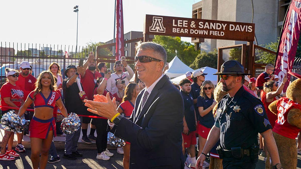 Brent Brennan walks during the Wildcat Walk before a football game in Tucson, Arizona.