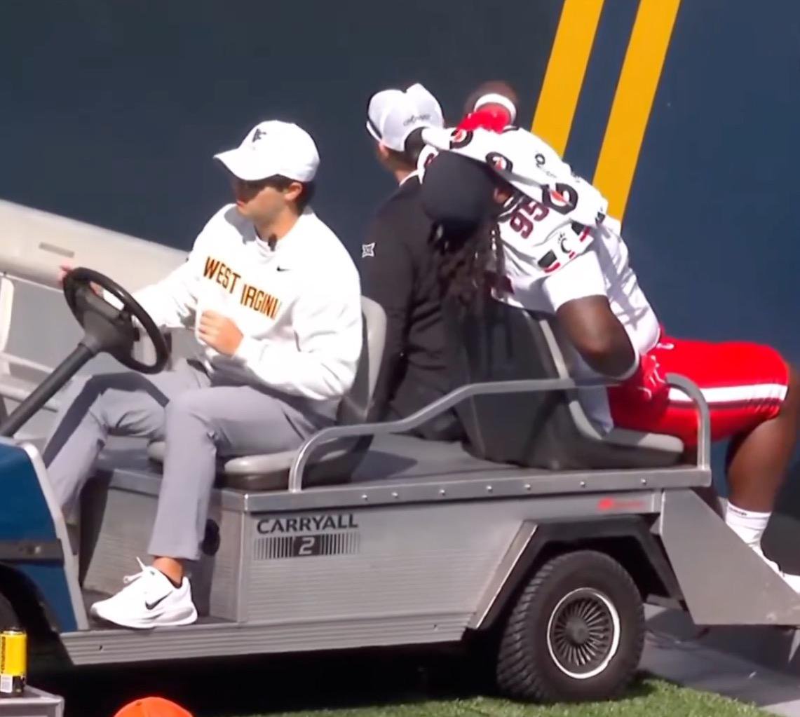 Cincinnati defensive tackle Josh Hough is carted off the field during a game against West Virginia.