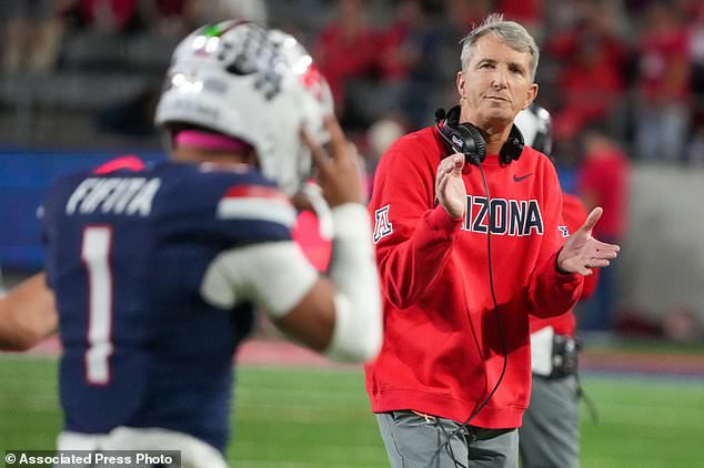 Arizona head coach Brent Brennan, right, claps for quarterback Noah Fifita (1) after Nifita's passing touchdown against Iowa State during the second half of an NCAA college football game Saturday, Oct. 24, 2026, in Tucson, Ariz. (AP Photo/Darryl Webb)