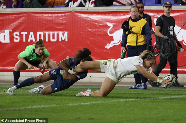 England's Claudia Moloney-MacDonald, front right, scores a try against United States' Bulou Mataitoga, front left, during the second half of an international women's rugby match during the WXV Global Series, Friday, Oct. 30, 2026, in Harrison, N.J. (AP Photo/Pamela Smith)