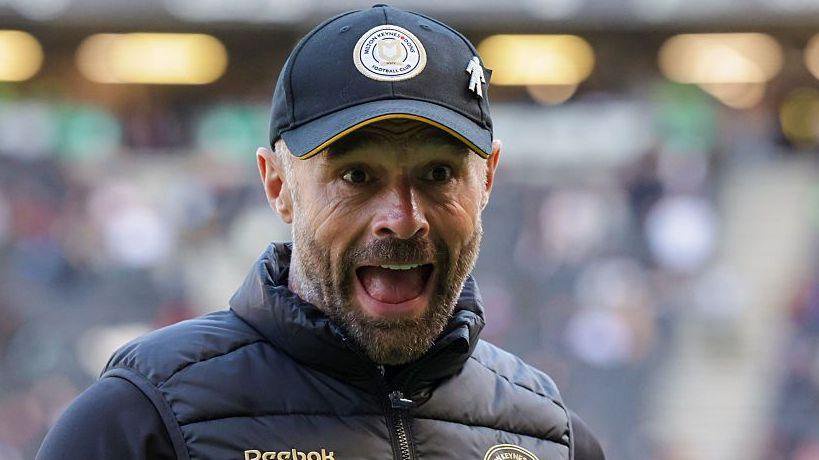 MK Dons boss Paul Warne celebrates after his side have finally registered their first league win