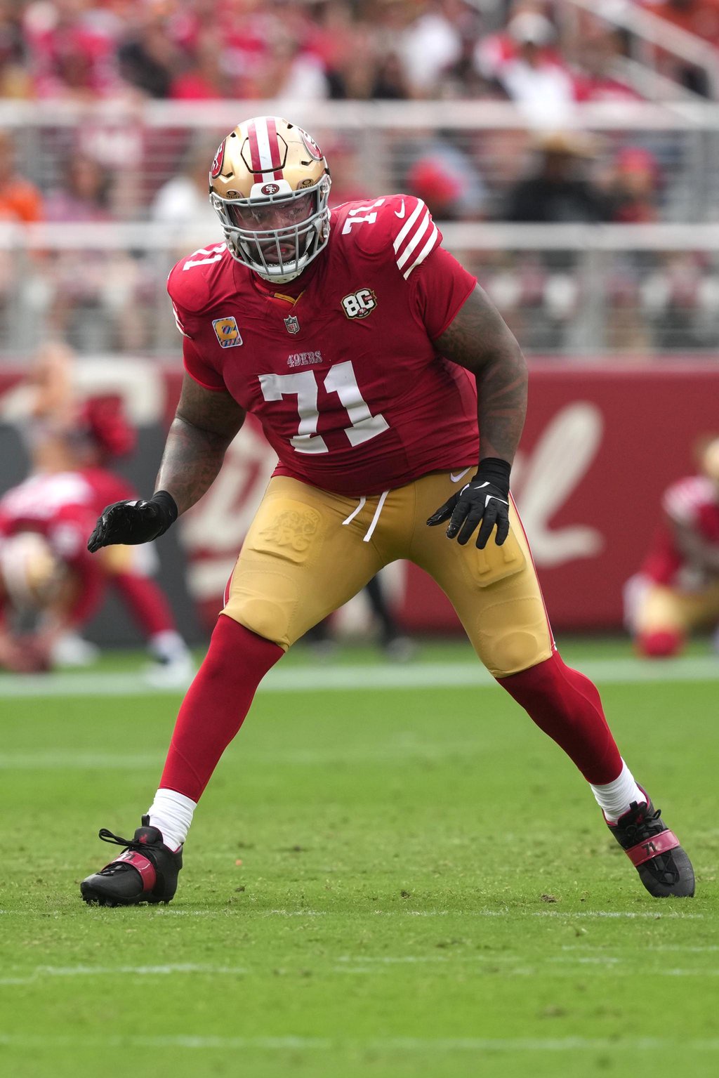 San Francisco 49ers offensive lineman Trent Williams (71) lines up on the field.