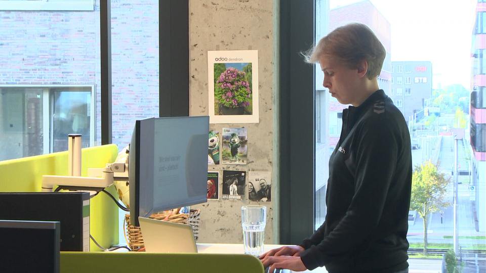 Amelie Brüning steht an einem Schreibtisch.